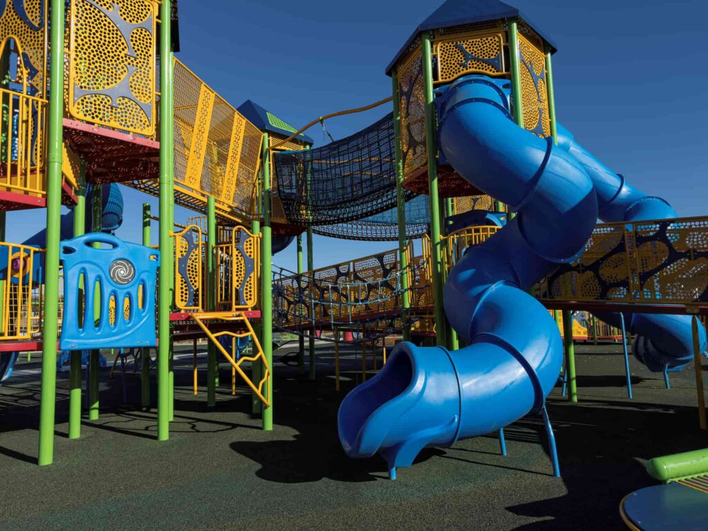 Playground with large blue twisting slide. 