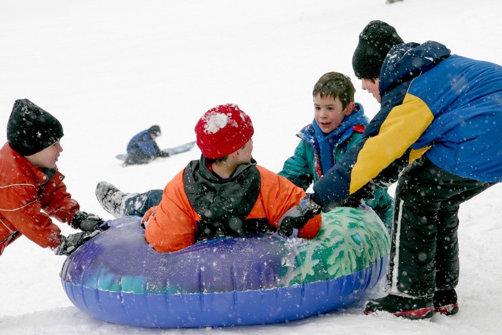 Group of Children Snow Tubing