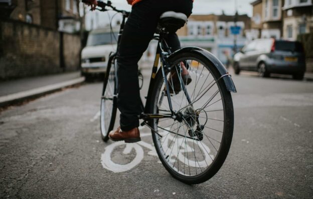 A person riding a bike across a street.