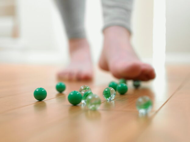 A person about to slip on green marbles