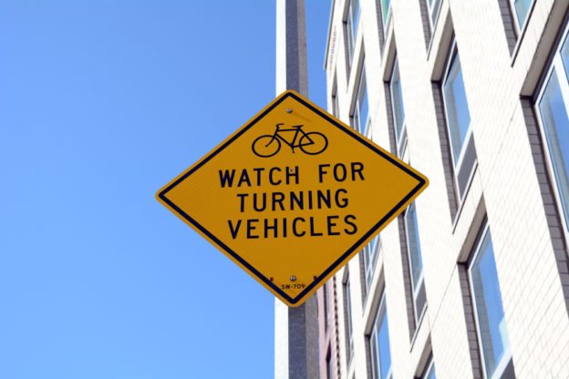 Watch for turning vehicles sign