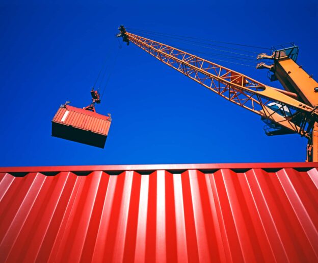 A crane picking up a container