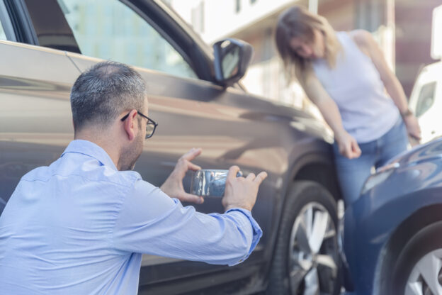 Man taking picture of a car accident