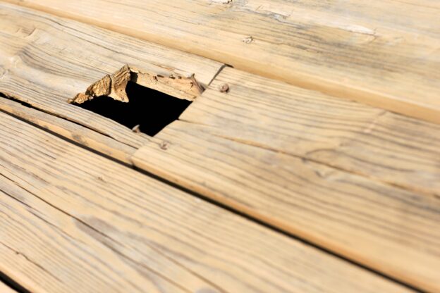 Wooden floor with large hole.
