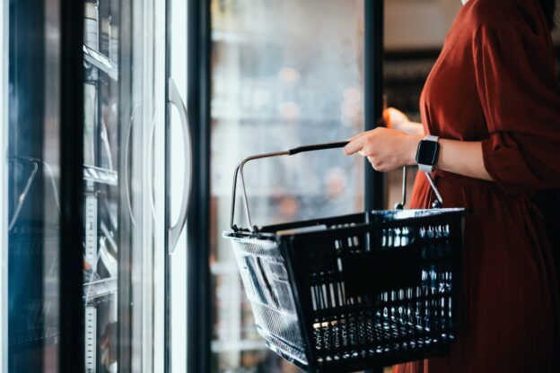 Person at Convenience Store Looking Inside Fridge