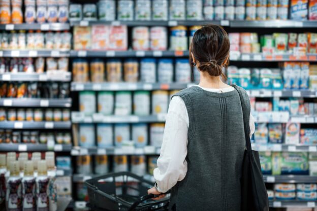 Woman looking at products on a shelf at a pharmacy